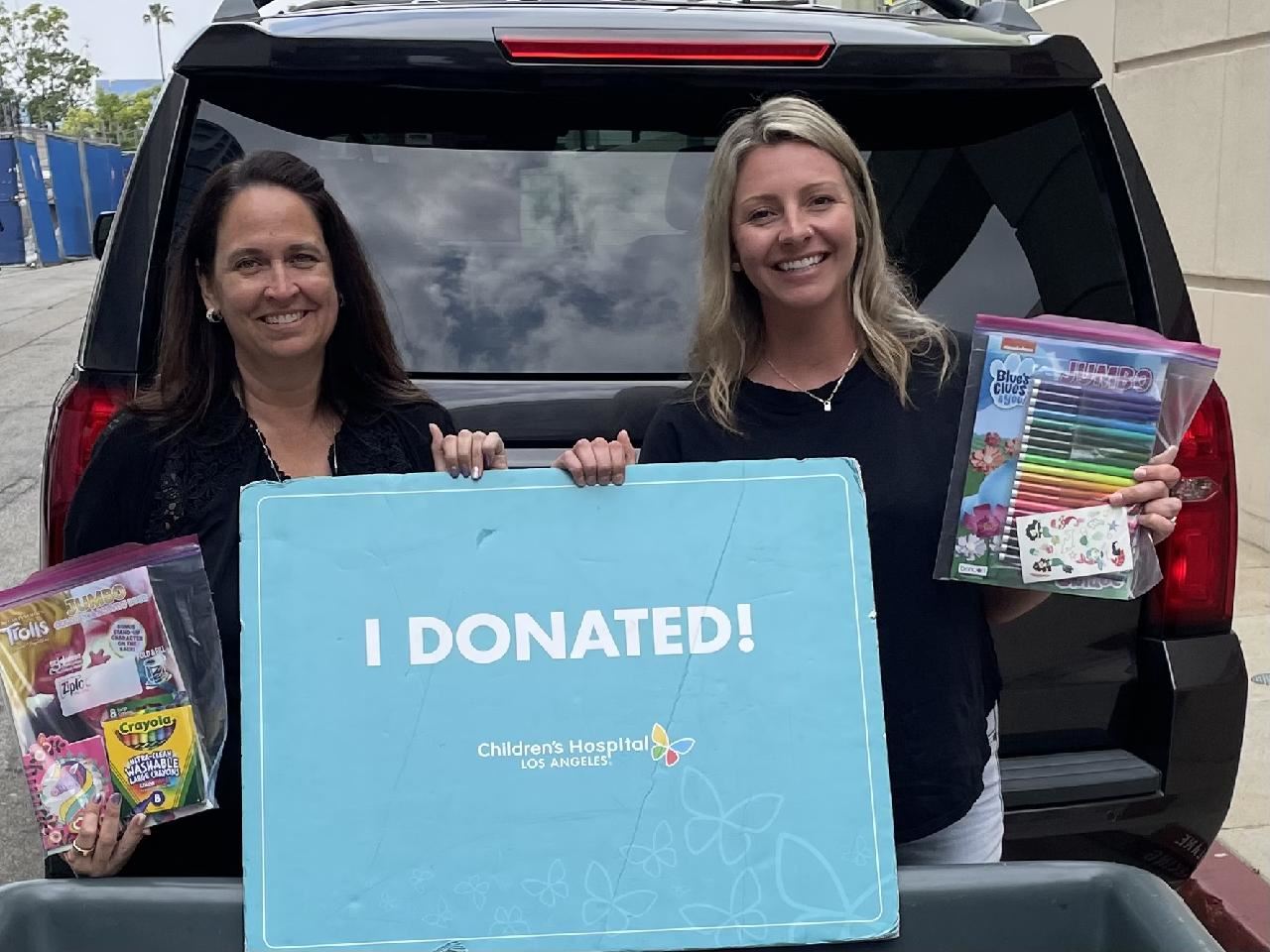 Staff holding a sign for our donation